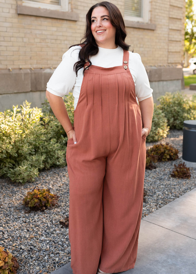 Plus size rust wide leg overalls with pleats at the bust