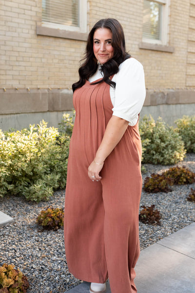 Front view of the rust wide leg overalls in plus size