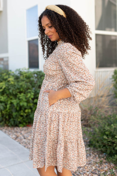 Side view of the beige floral smocked dress