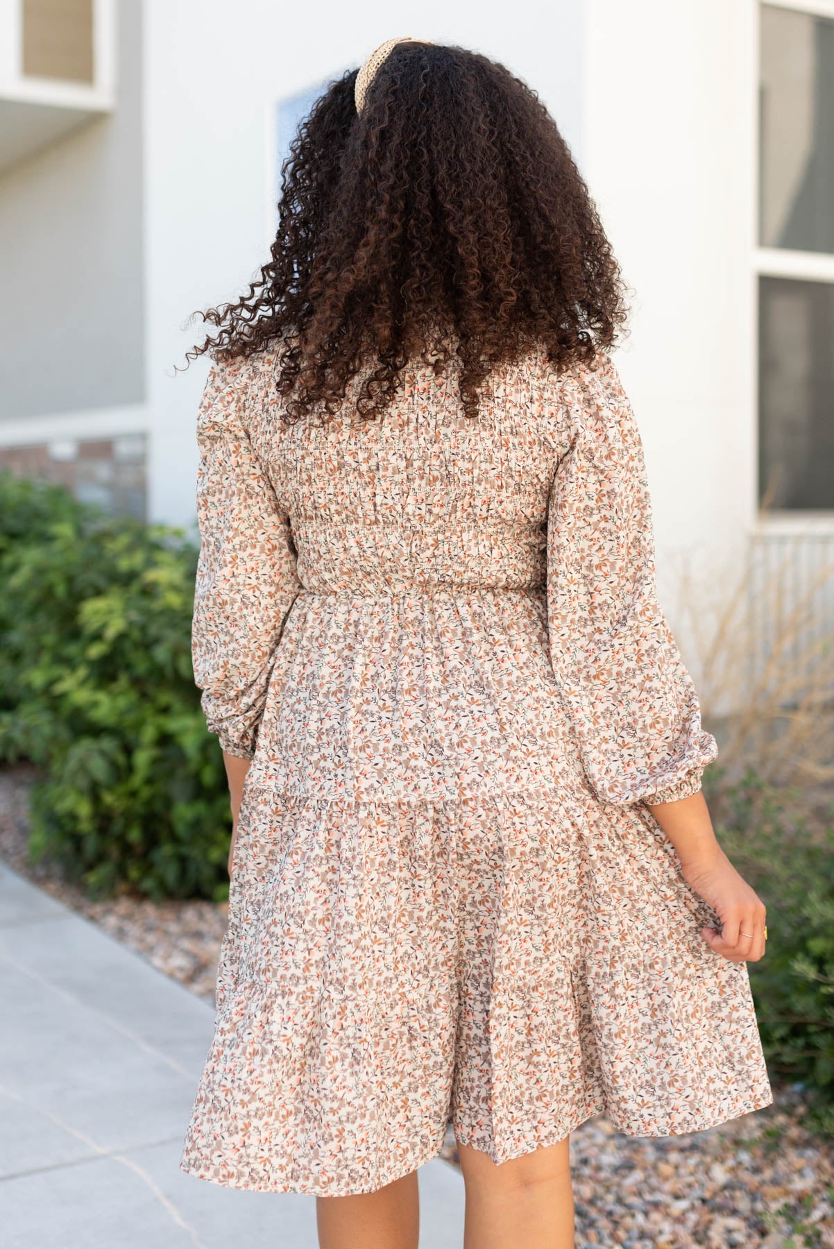 Back view of the beige floral smocked dress