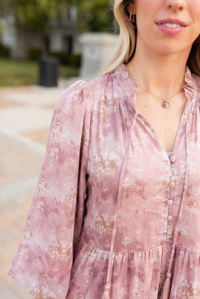 Close up of the neckline and fabric on the mauve flroal tiered dress