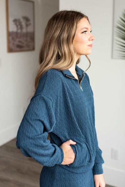 Side view of the navy knit pullover