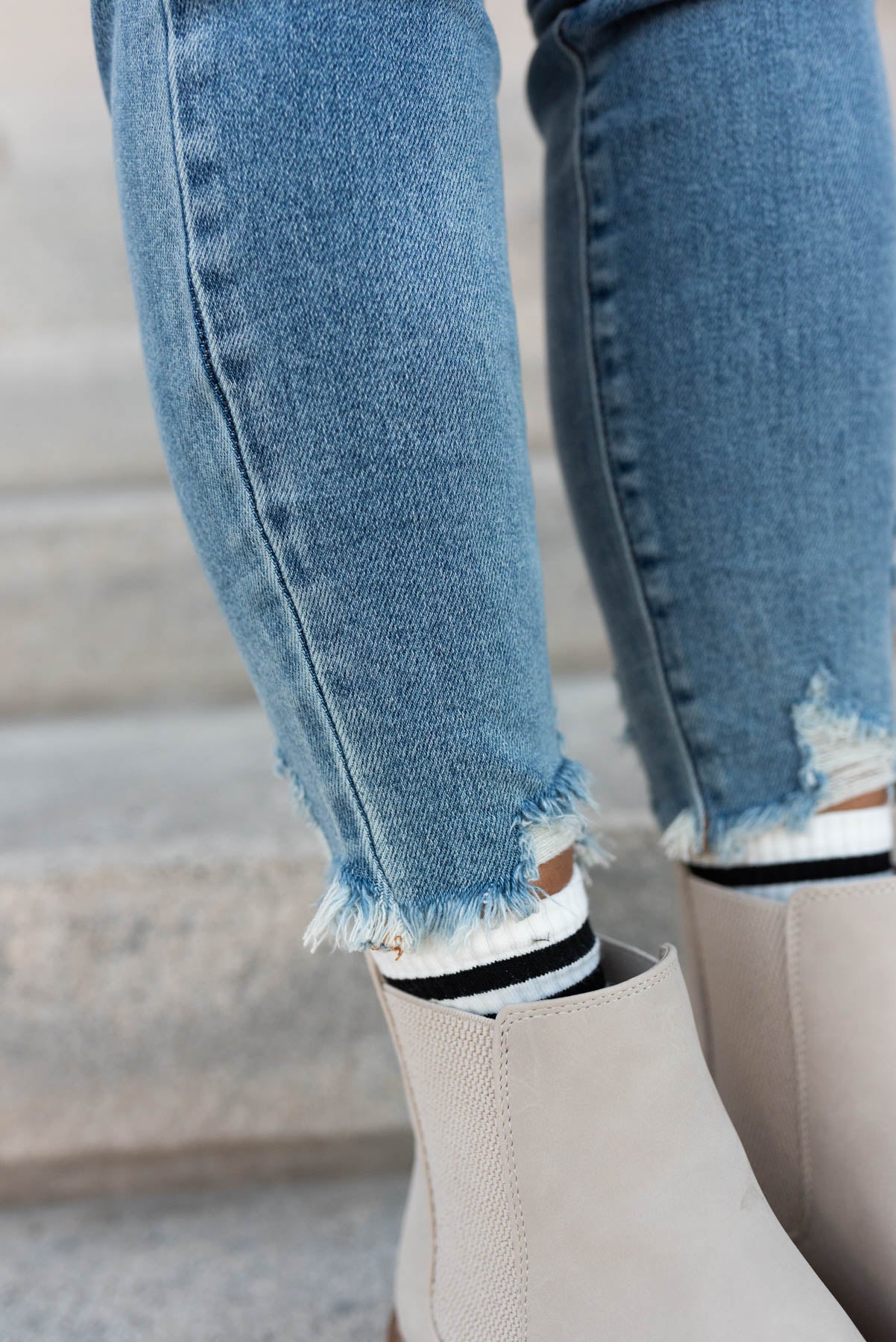 Close up of the cuffs on the medium wash skinny jeans