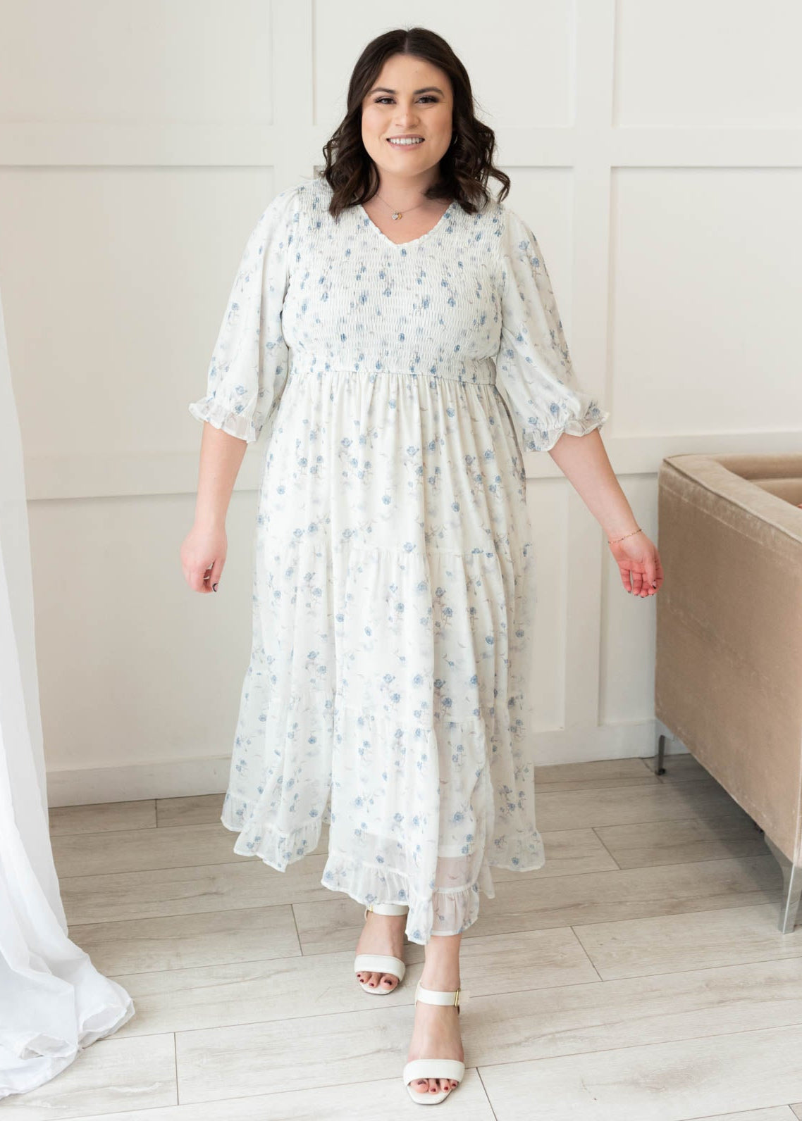 Three quarter sleeves on the light blue flroal tiered dress in plus size