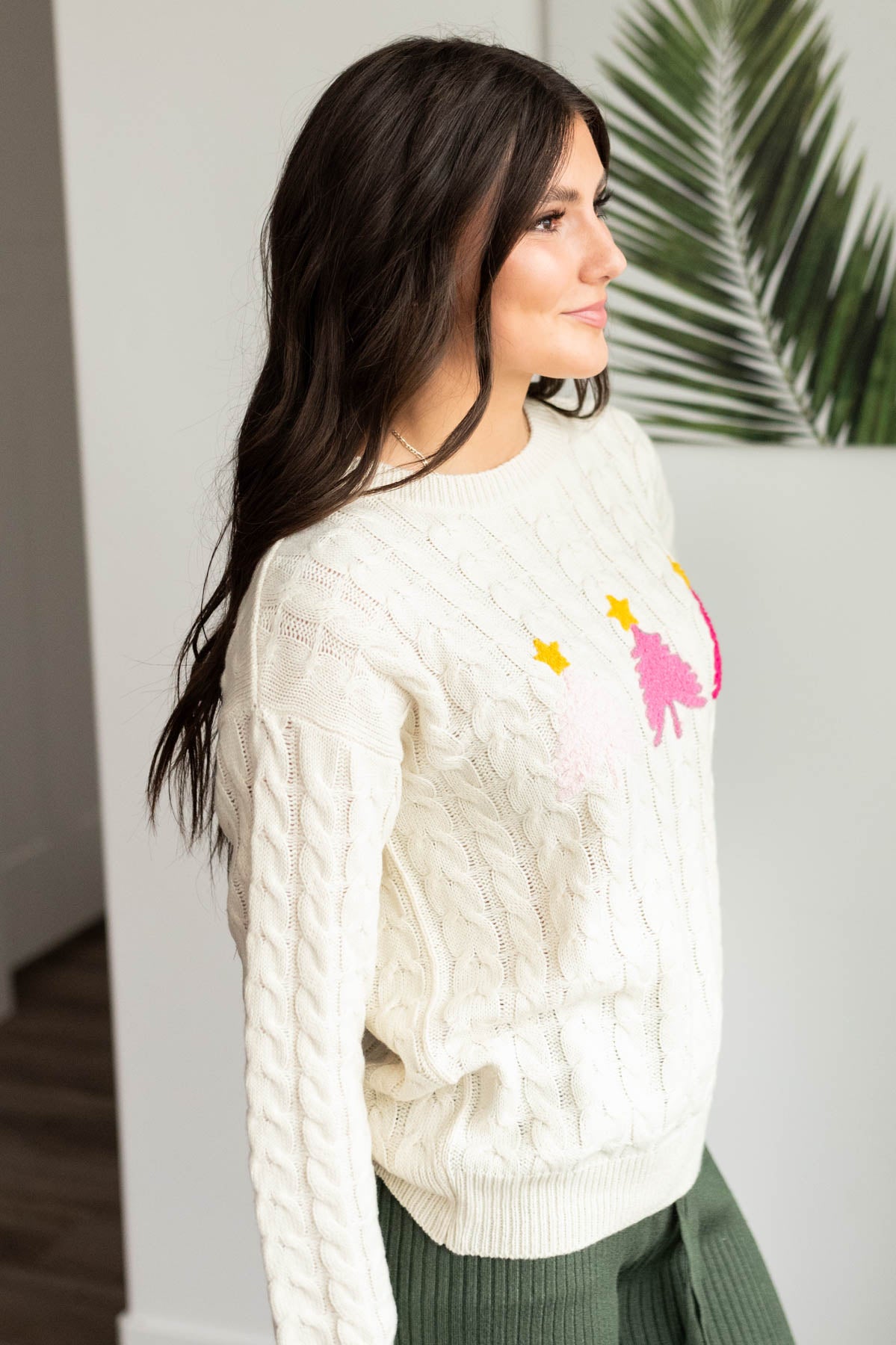 Side view of the cream embroidered tree sweater