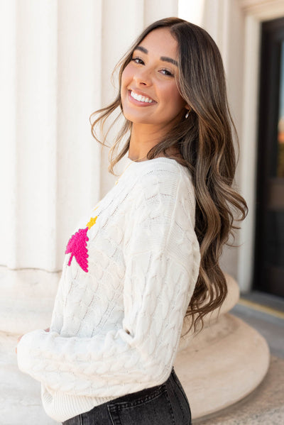 Side view of the cream embroidered sweater