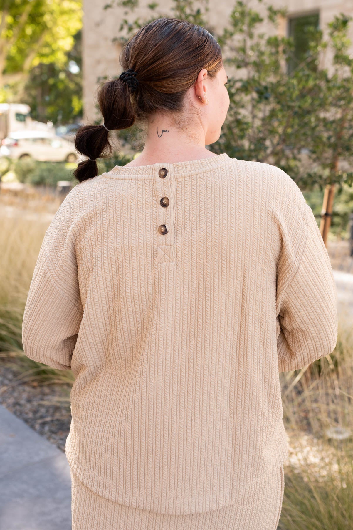 Back view of the beige textured top