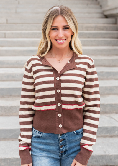 Brown button down sweater with brown cuffs and waist banding.