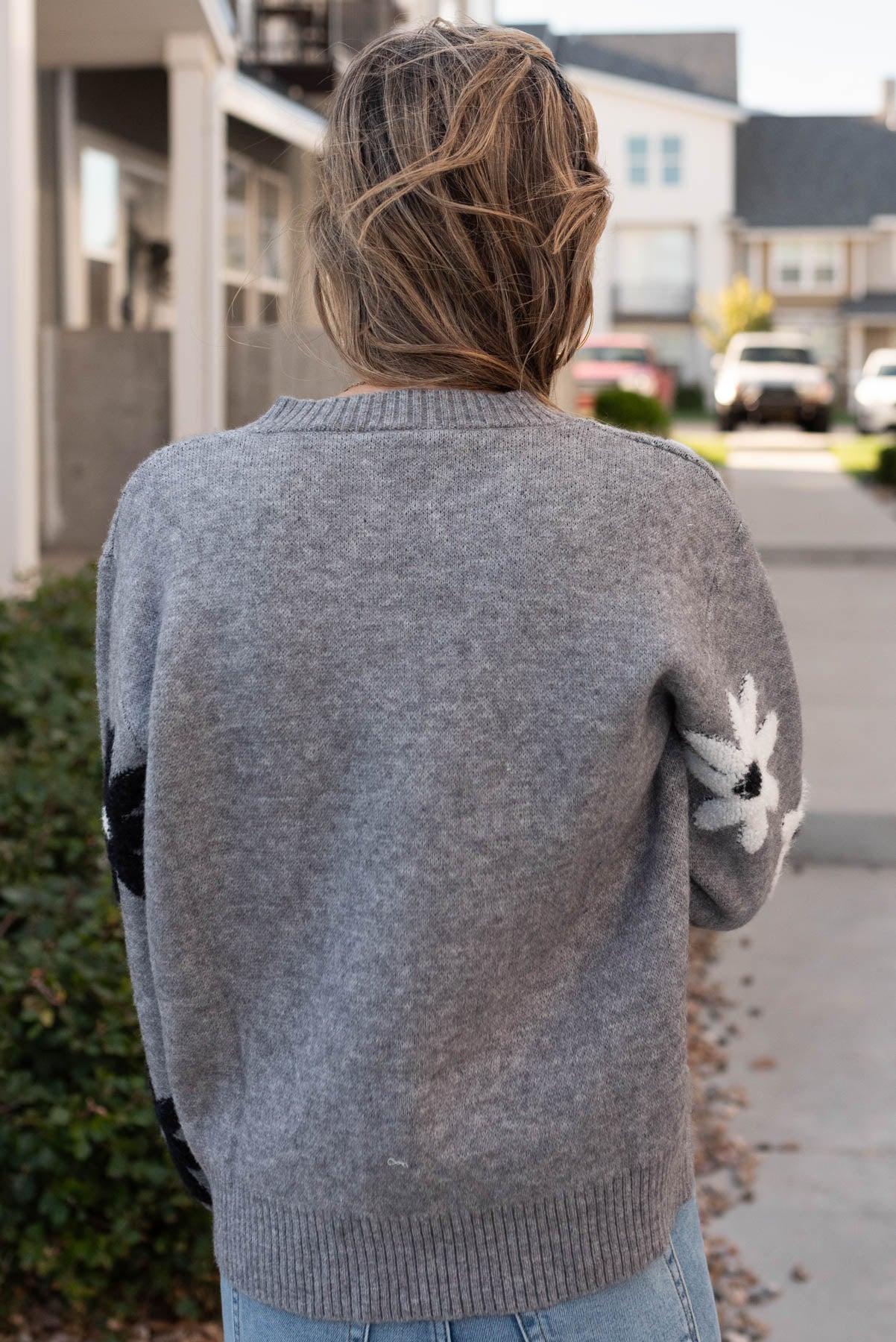 Back view of the grey floral sweater