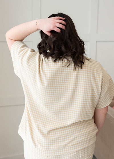 Back view of the plus size beige gingham knit top