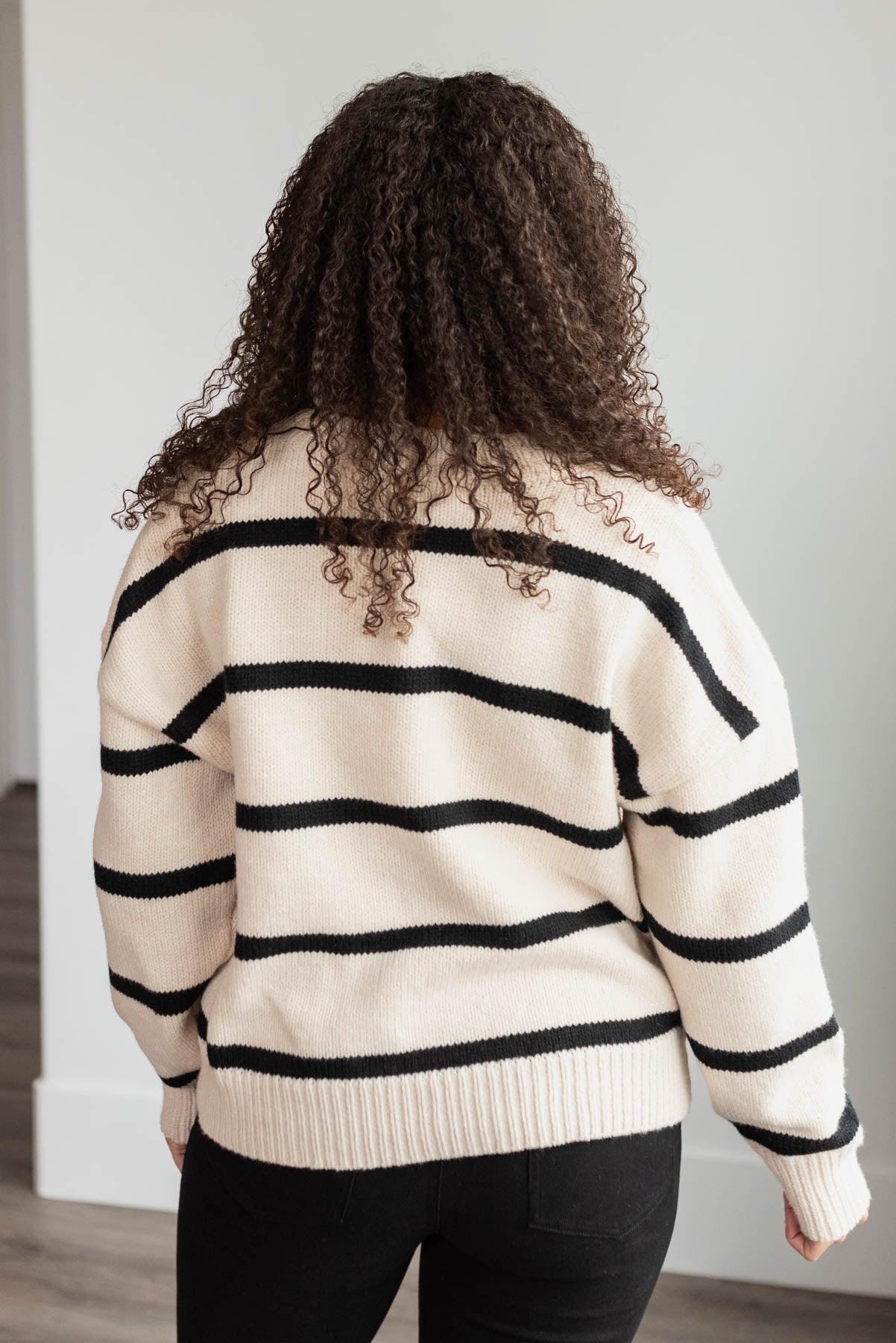 Back view of the black stirpe sweater