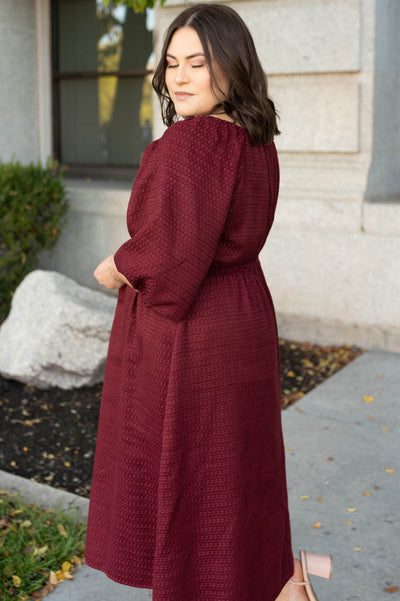 Side view of the plus size burgundy textured dress