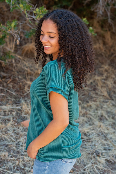 Side view of the hunter green ribbed top