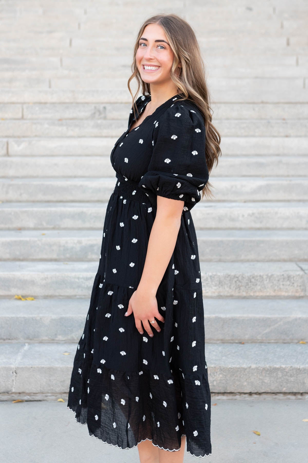 Side view of the black embroidered button dress