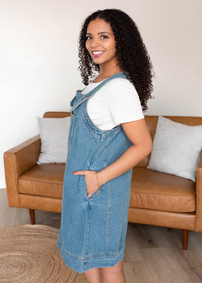 Side view of the washed denim overall dress