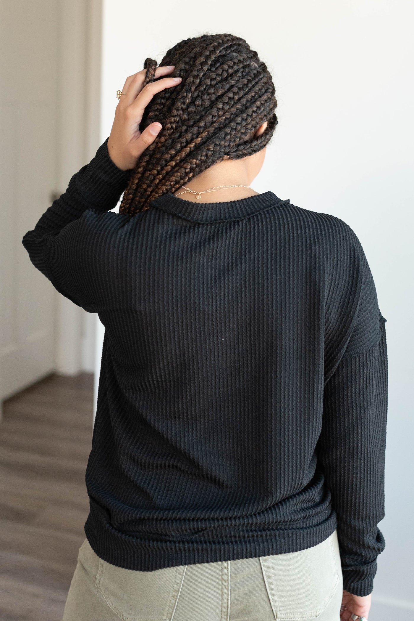 Back view of the black ribbed long sleeve top