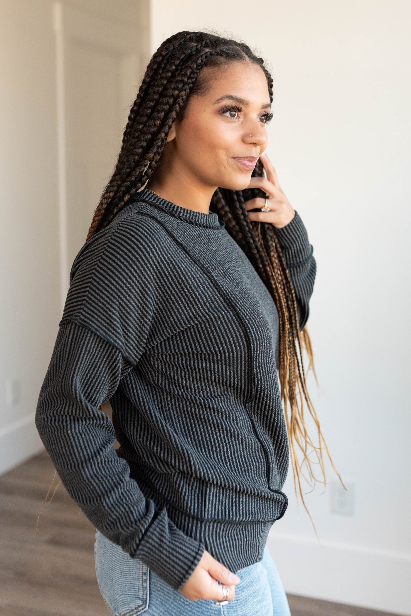 Side view of the charcoal ribbed long sleeve top