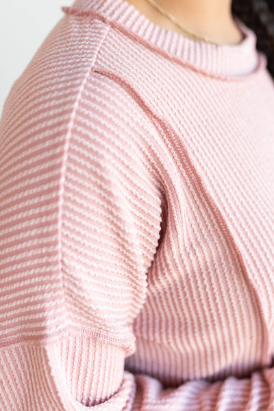 Close up of the fabric on the light rose ribbed long sleeve top