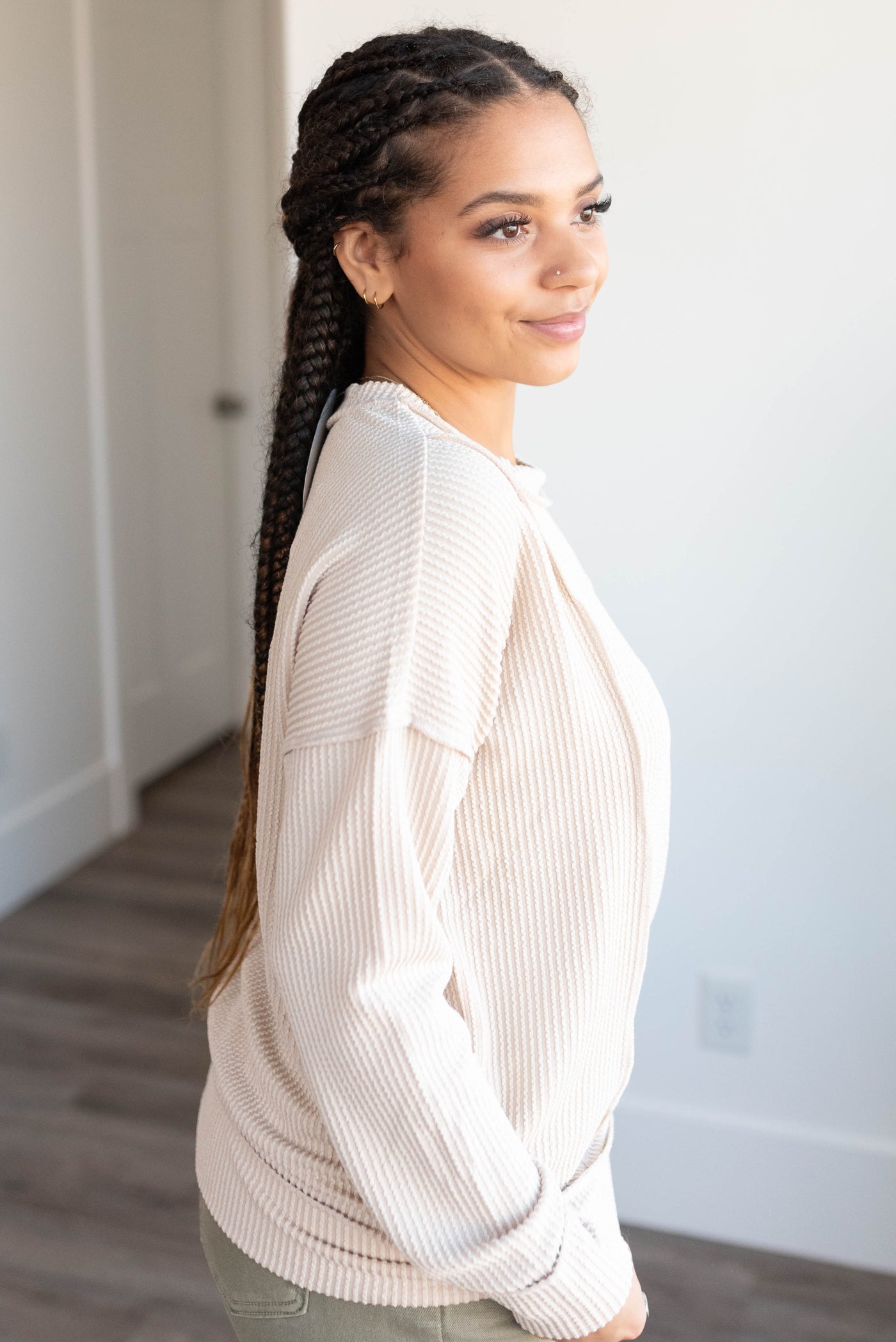 Side view of the sand beige ribbed long sleeve top