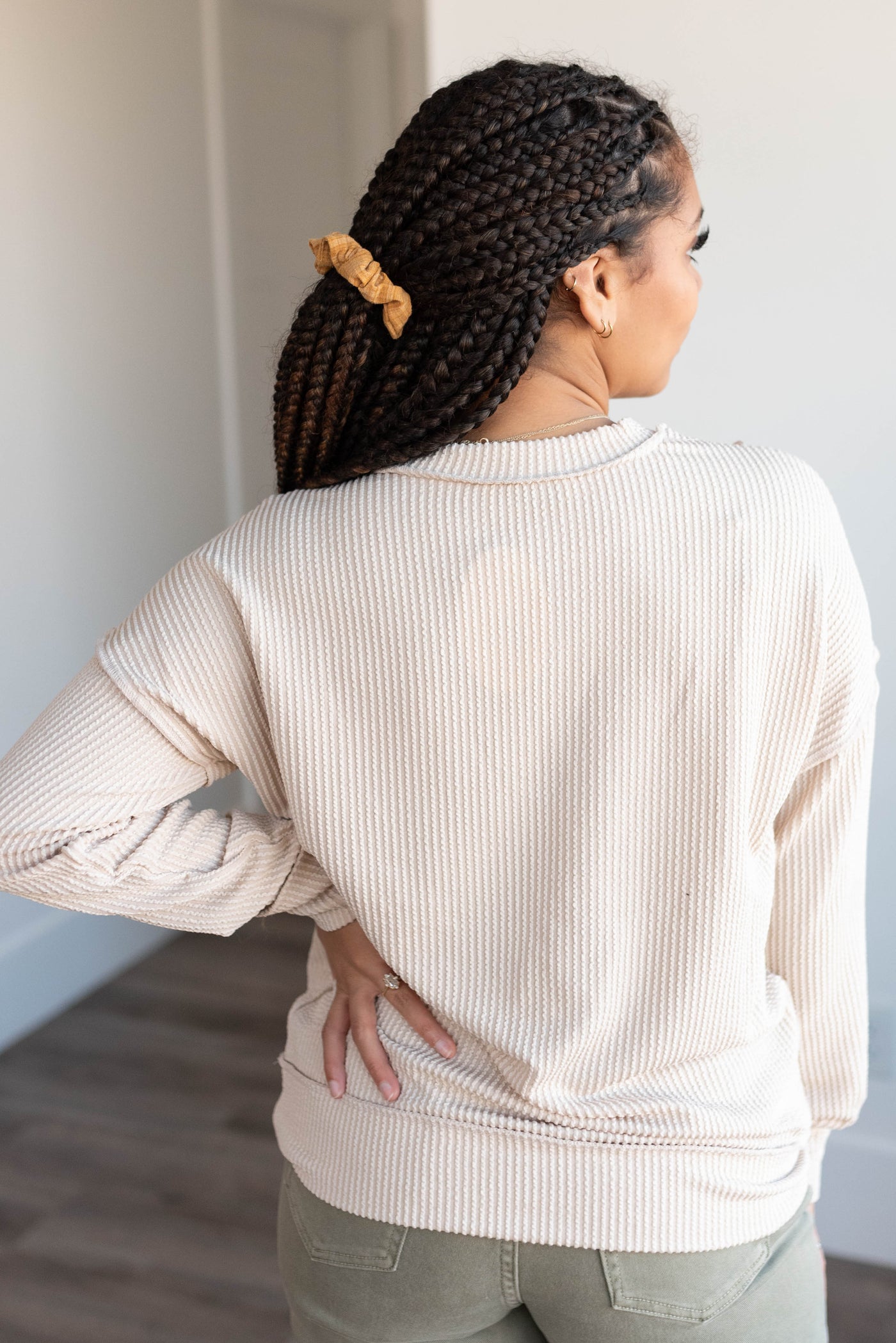 Back view of the sand beige ribbed long sleeve top