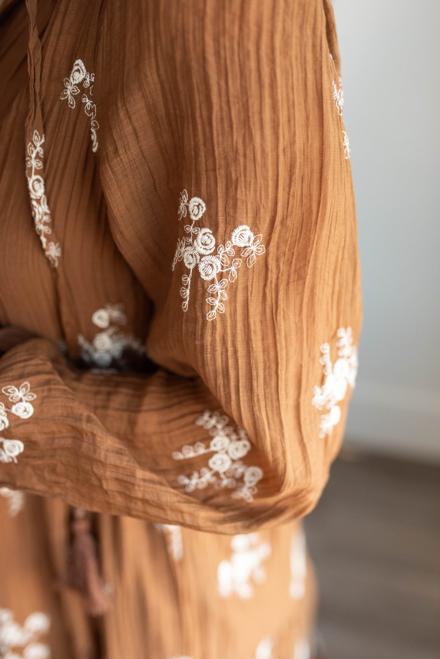 Close up of the fabric on the brown embroidered dress