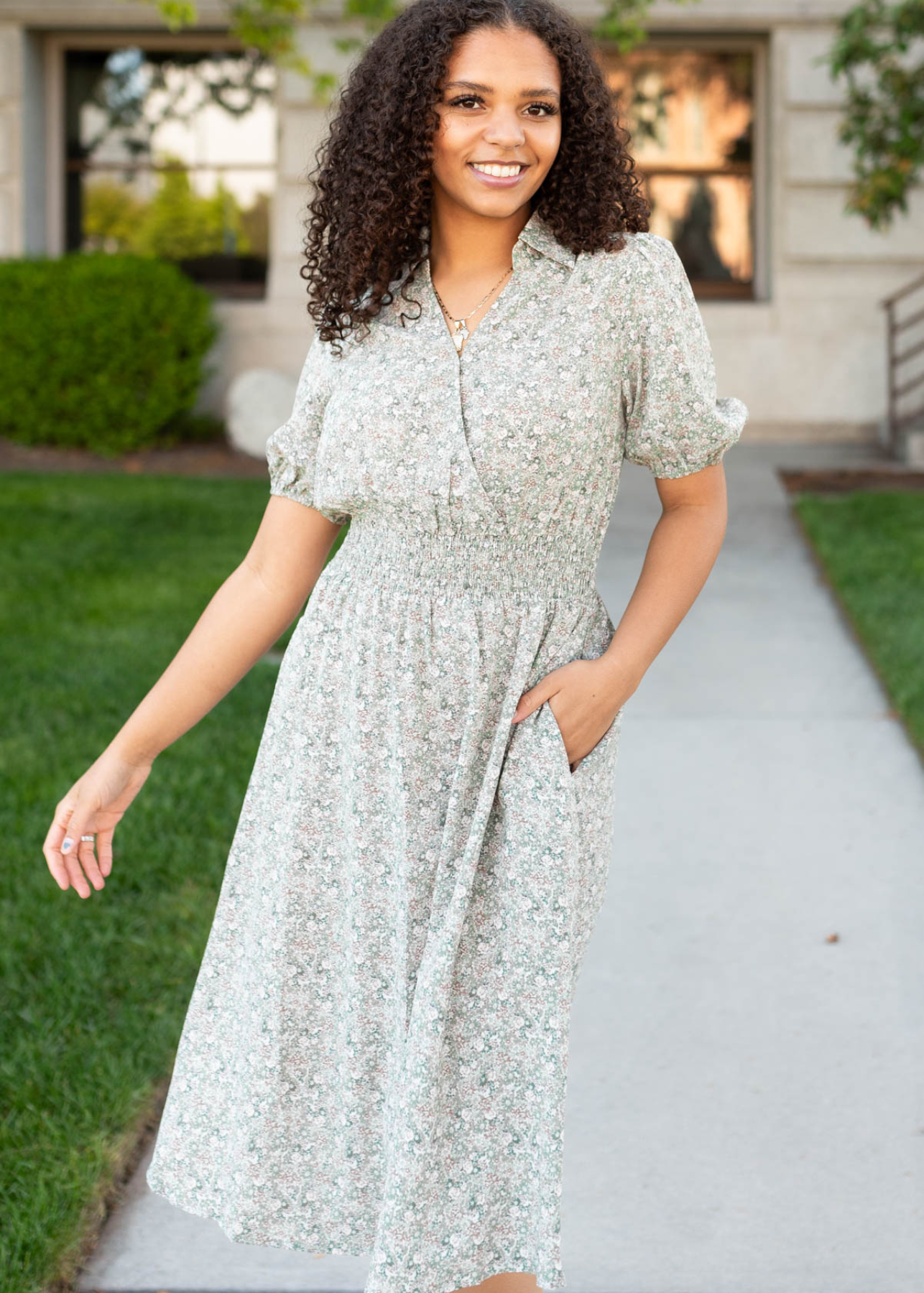 Olive floral midi dress with wide elastic waist and wrap style bodice.