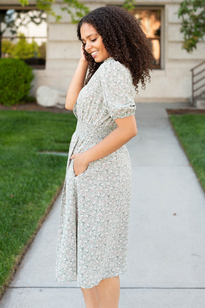 Side view of the olive floral midi dress with pockets