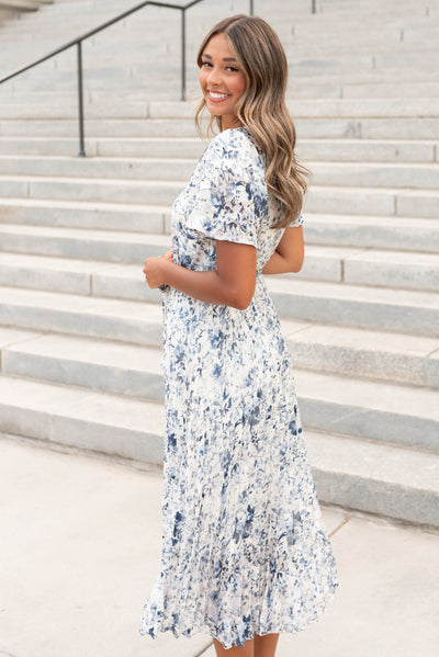 Side view of the blue floral pleated dress