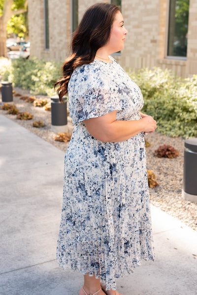 Side view of the plus size blue floral pleated dress