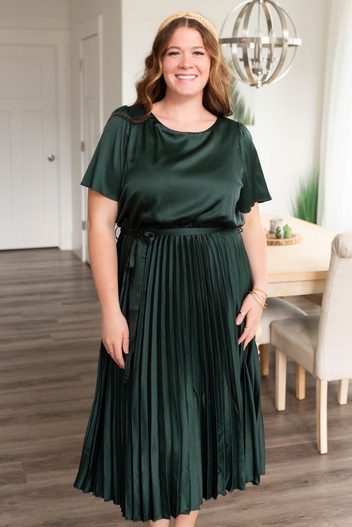 Front view of the hunter green satin pleat dress in plus size