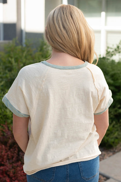 Back view of the creams sage pocket top