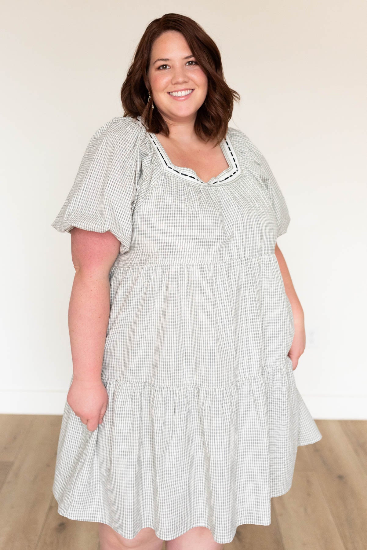 Plus size black checkered dress with a square neck and black and white trim