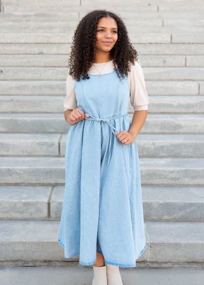 Light denim jumper dress with tie at the waist