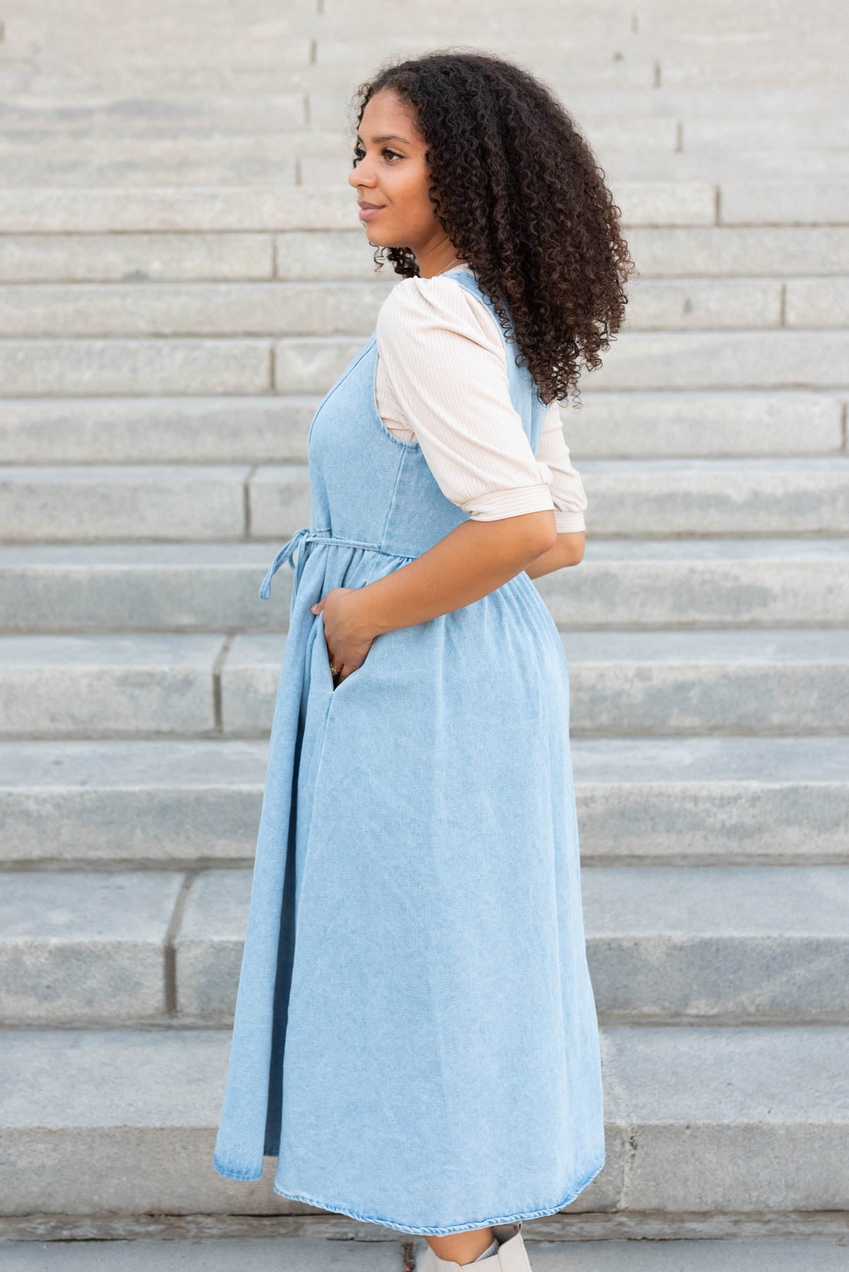 Side view of the light denim jumper dress