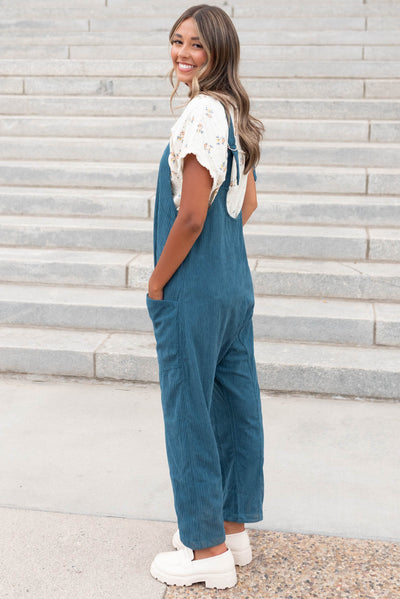 Side view of the deep aqua corduroy overalls