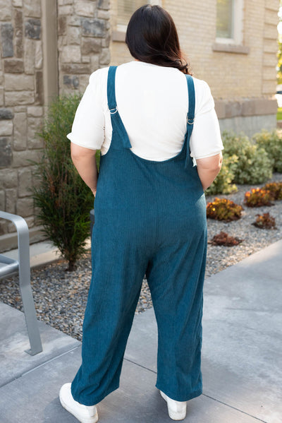 Back view of the deep aqua corduroy overalls in plus size