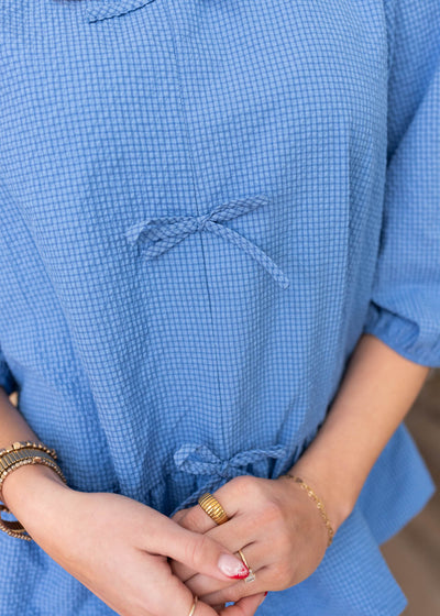 Close up of the bows on the blue tiered top