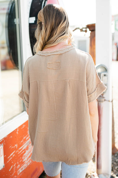 Back view of a taupe gauze top