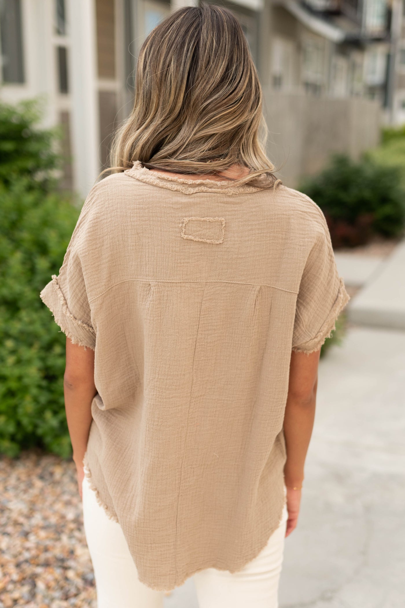 Back view of a short sleeve tan top