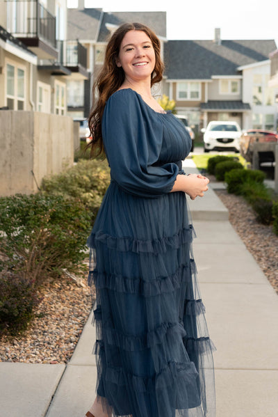 Side view of the navy long sleeve ruffle dress in plus size