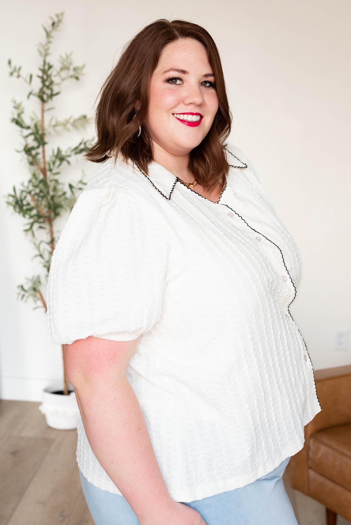 Side view of the cream collard top in plus size