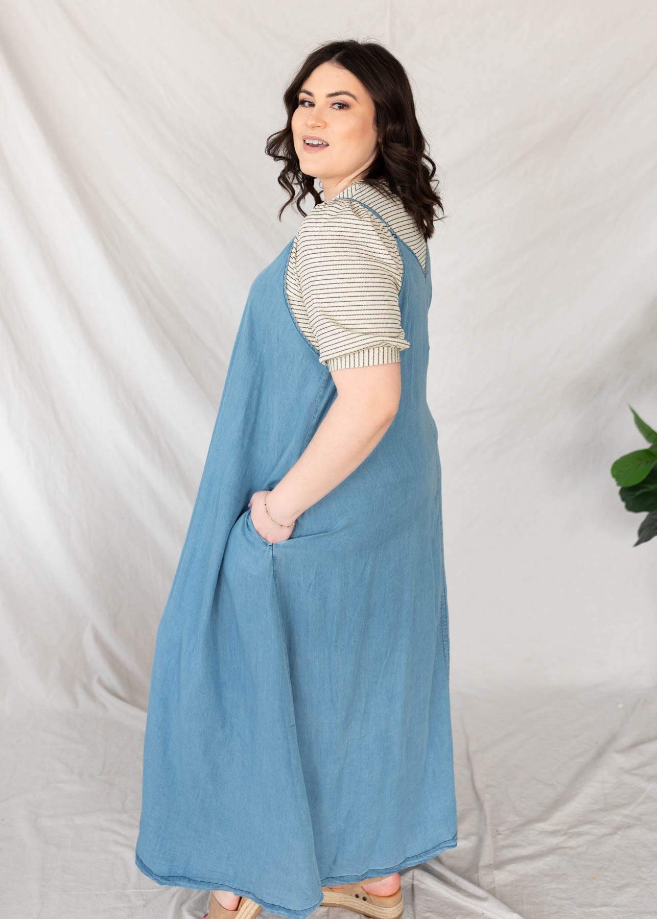 Side view of the plus size denim maxi dress with pockets