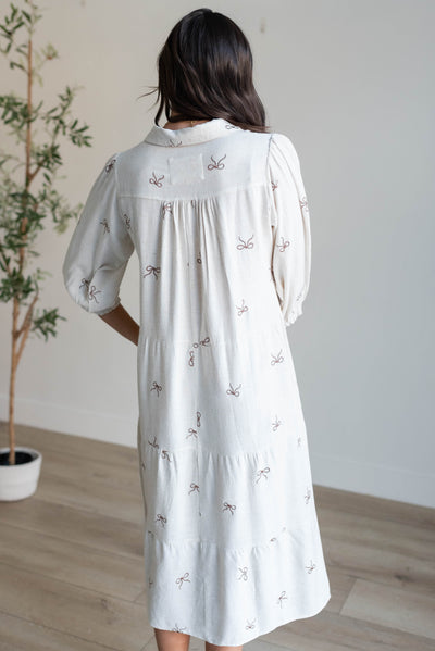 Back view of the oatmeal embroidered bow dress