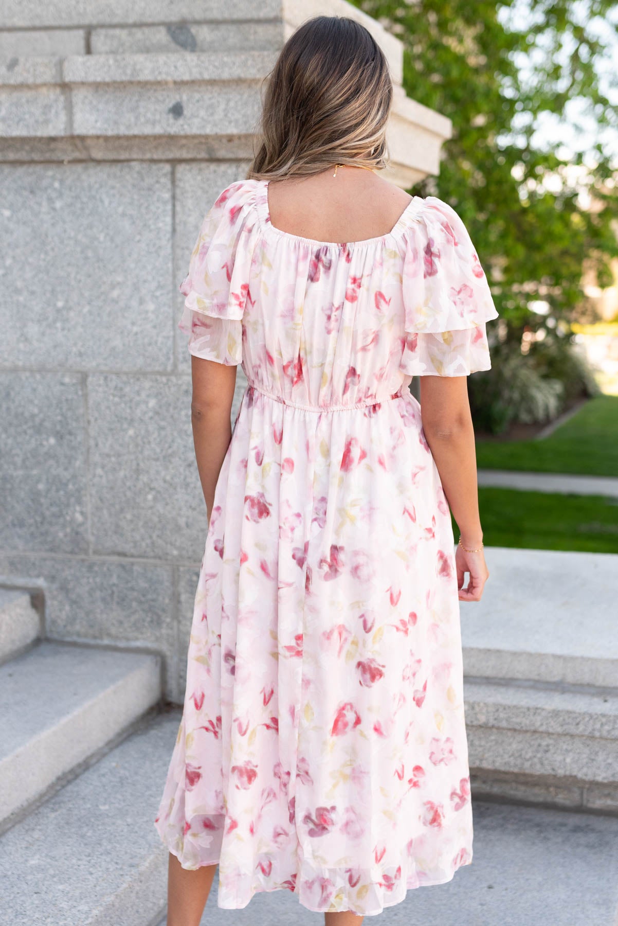 Back view of the blush watercolor floral dress