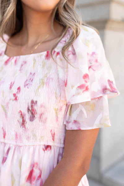 Close up of the sleeve and fabric on the blush watercolor floral dress
