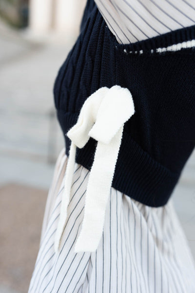 Close up of the bows on the navy knit sweater dress