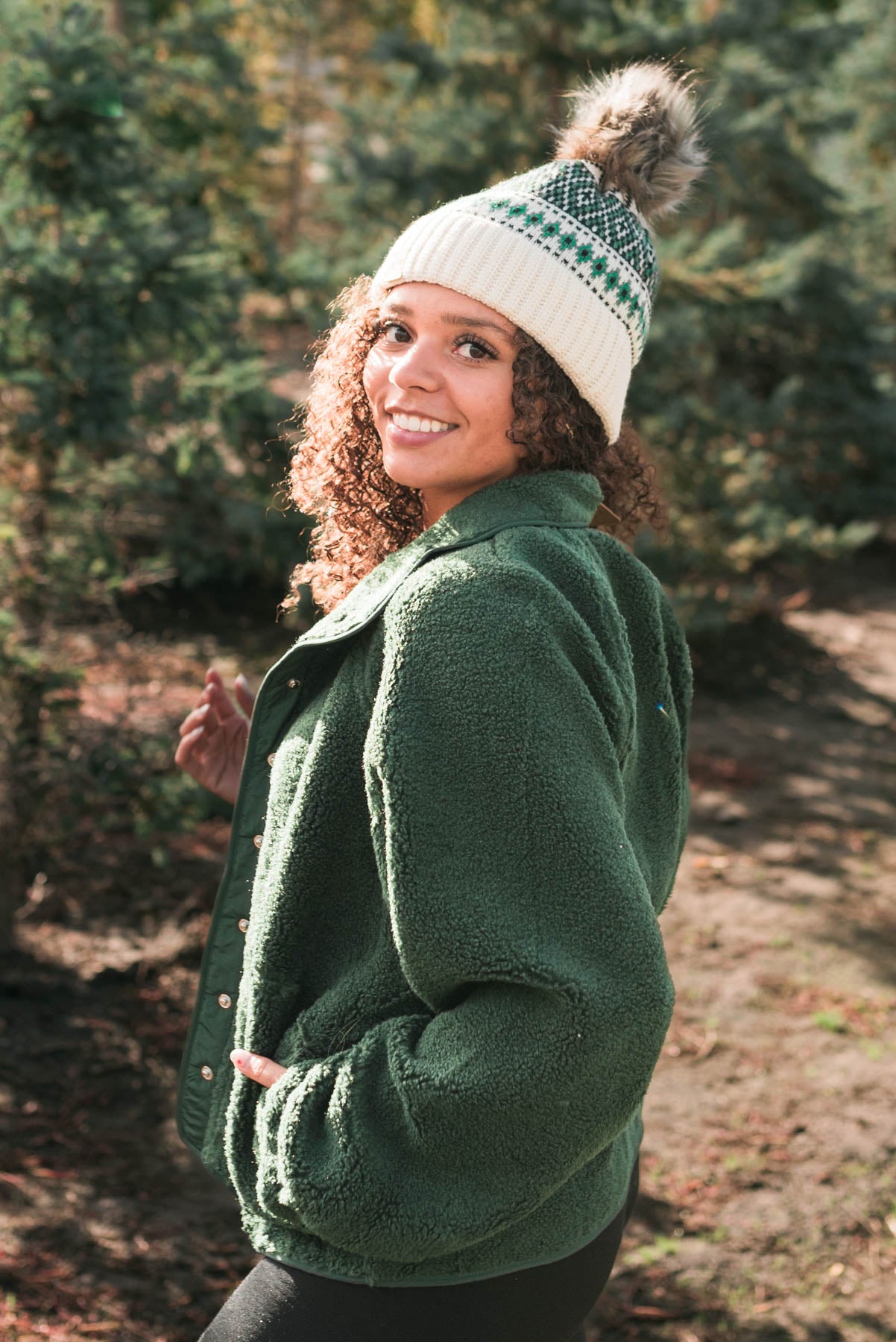 Side view of a hunter green fleece jacket