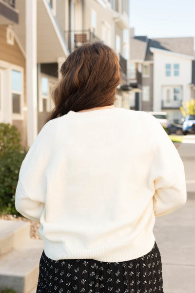 Back view of the plus size cream floral sweater