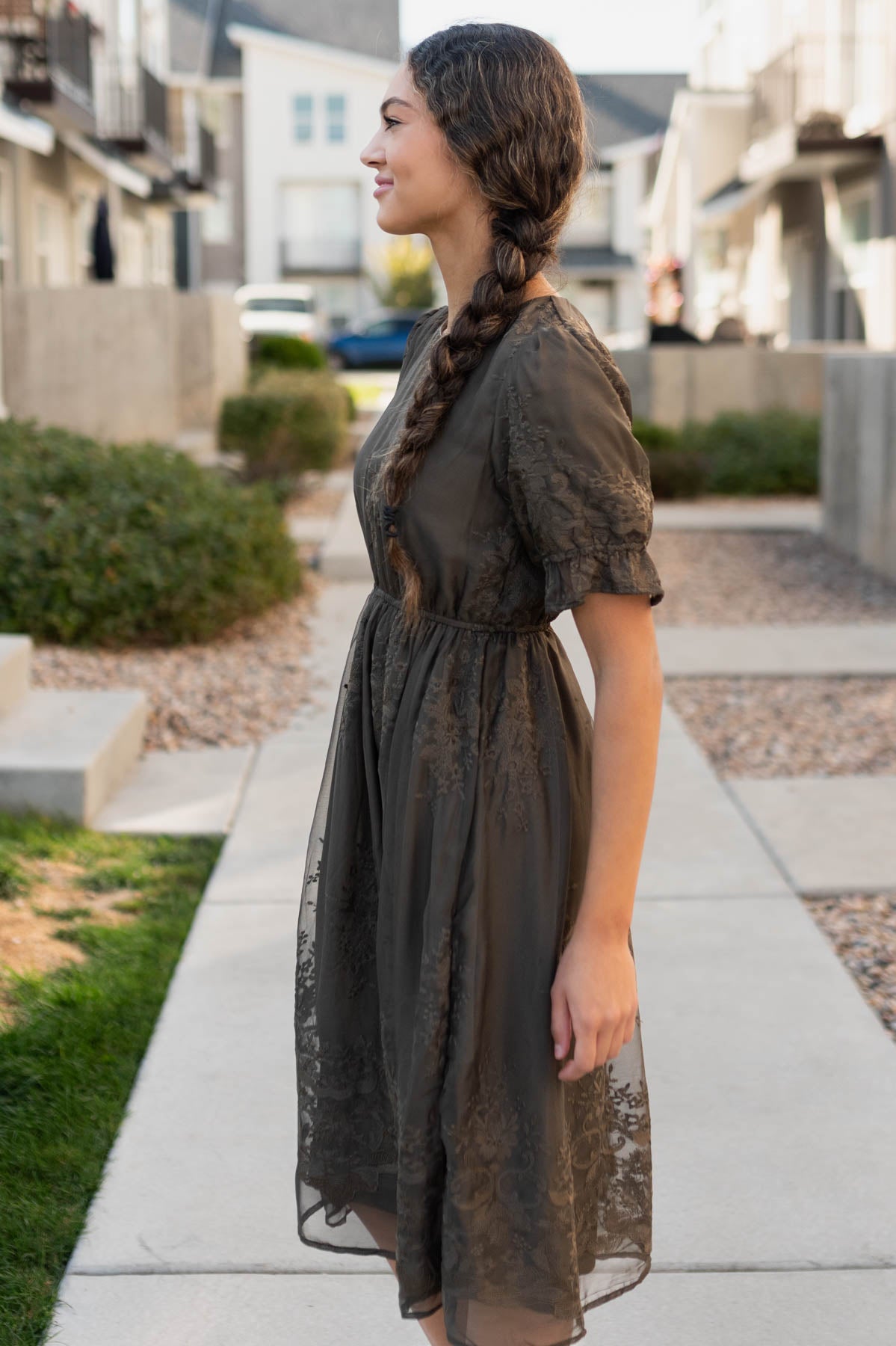 Side view of the dark olivie embroidered dress