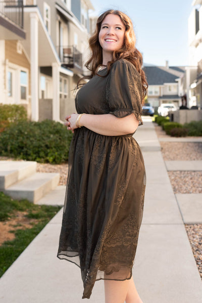 Side view of the dark olive embroidered dress in plus size